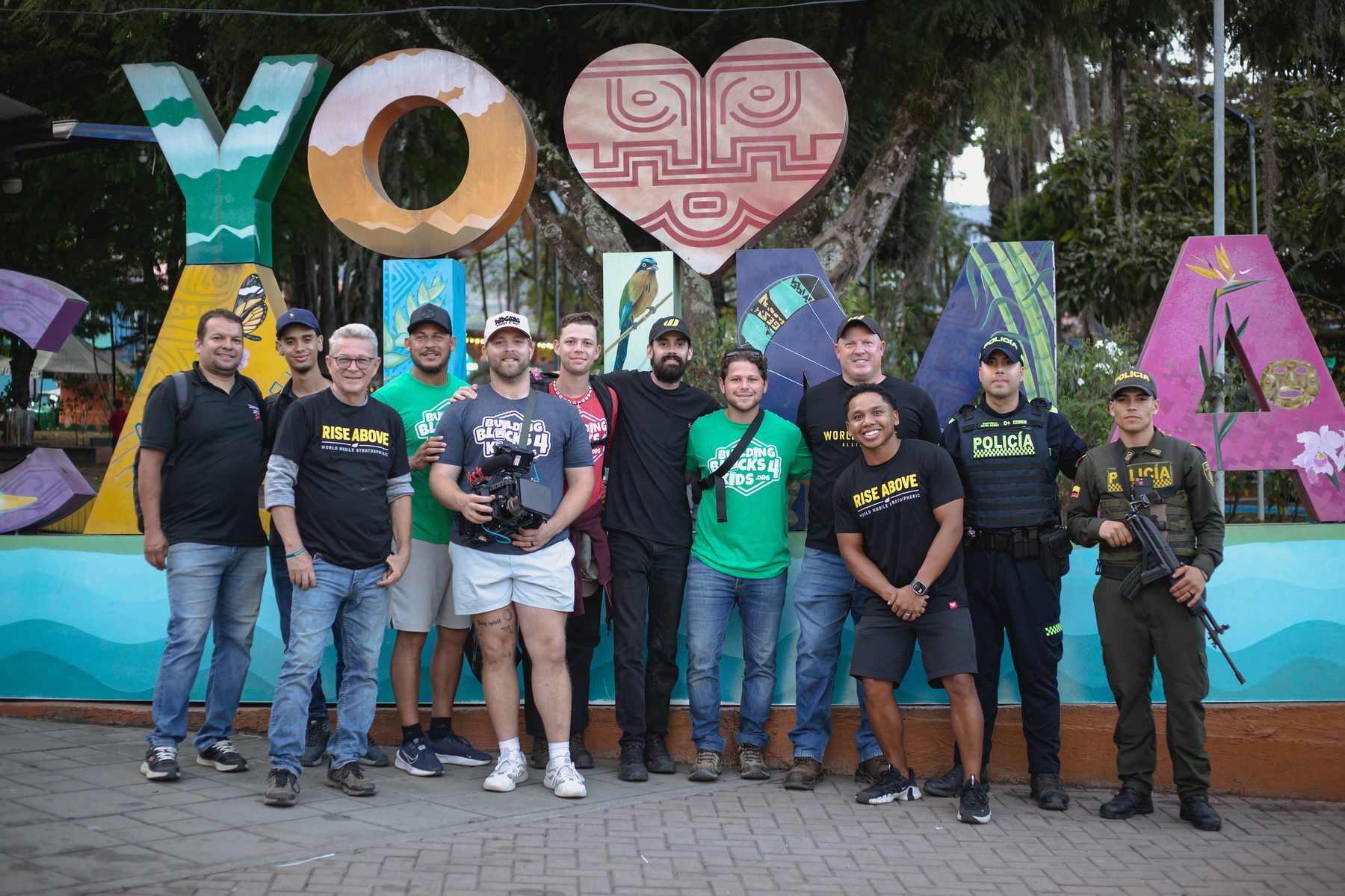 The team and two local police officers at the painted town sign at the end of the week